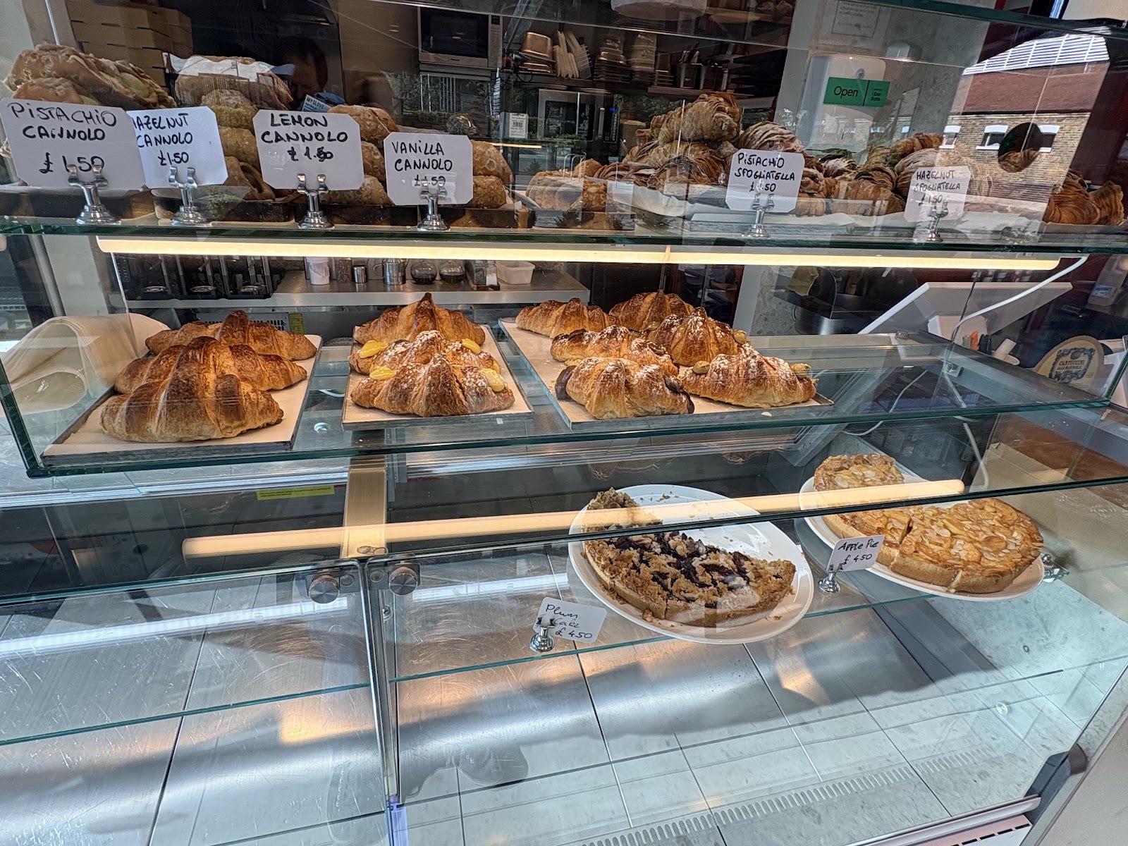 Trays of croissants and sfogliatelle in the pastry case