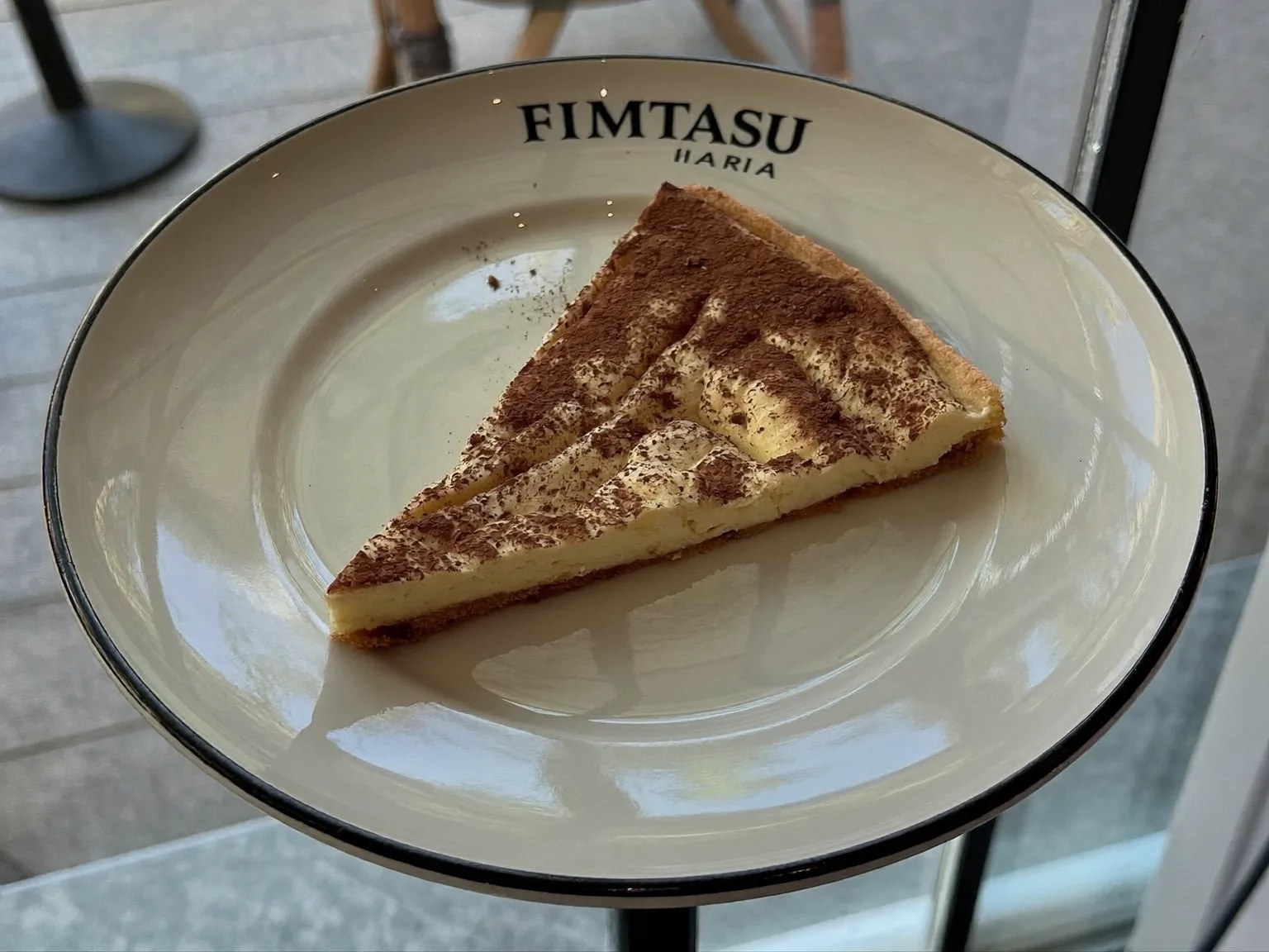 A slice of tiramisu on a white plate