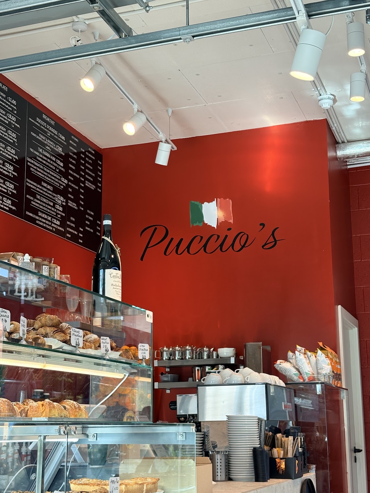 The shop interior with its red wall and pastry counter